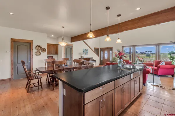 a kitchen with stainless steel appliances granite countertop sink stove refrigerator and cabinets