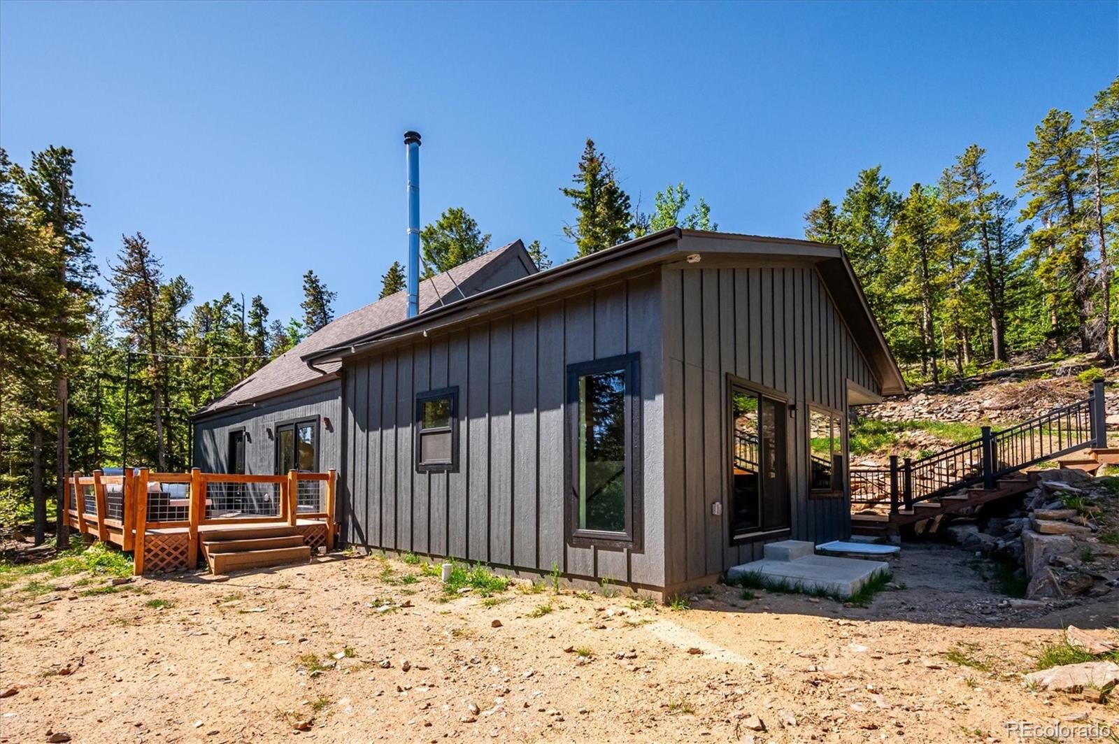 1633 Sinton Road Evergreen, CO 80439 - Photo 15 of 50 a view of a house with a patio