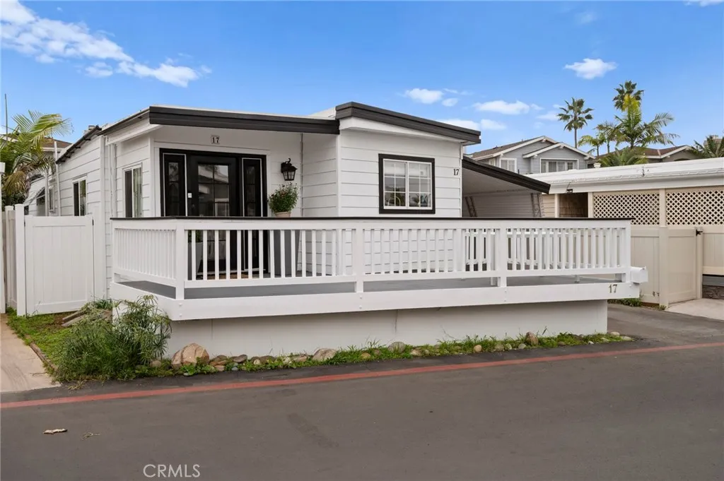 6550 Ponto, Unit 17 Carlsbad, CA 92011 - Photo 1 of 48 a view of a house with a small yard and wooden fence