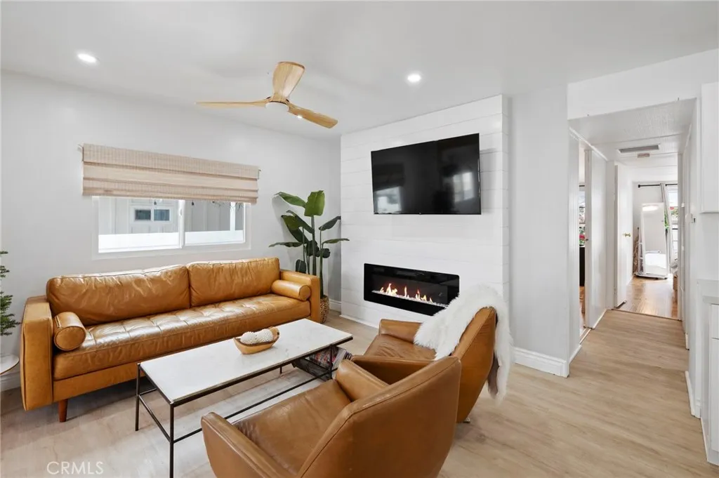 6550 Ponto, Unit 17 Carlsbad, CA 92011 - Photo 11 of 48 a living room with furniture a fireplace and a flat screen tv