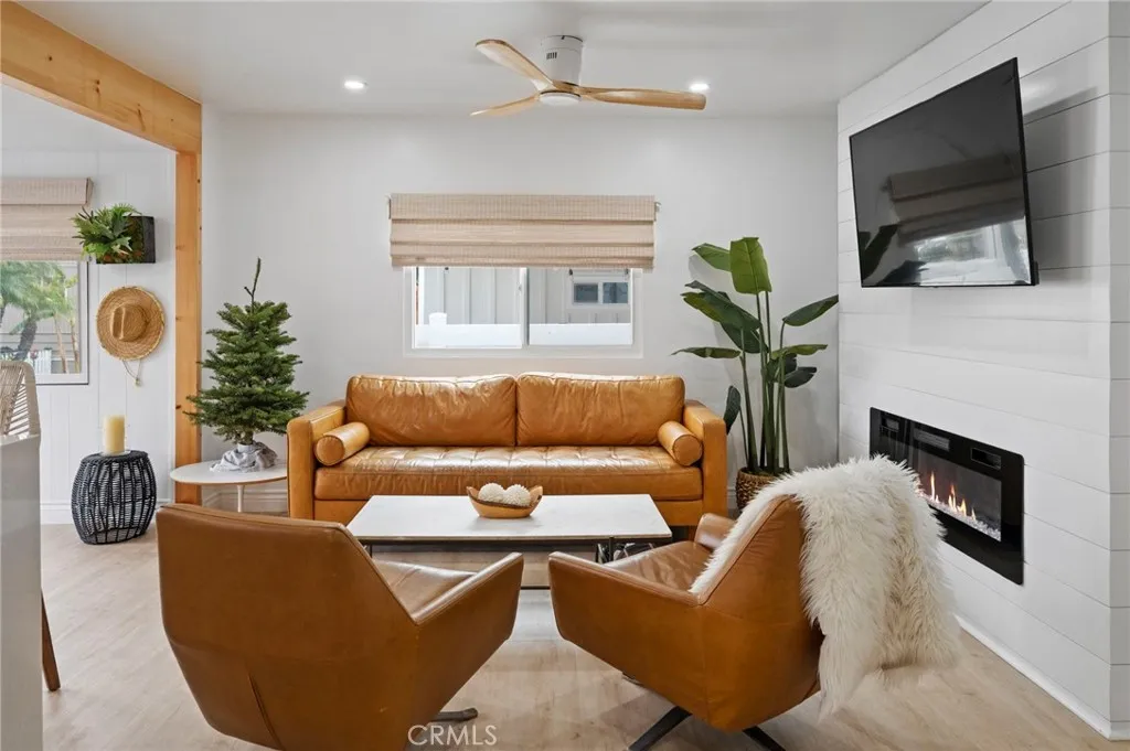 6550 Ponto, Unit 17 Carlsbad, CA 92011 - Photo 12 of 48 a living room with furniture a flat screen tv and a fireplace