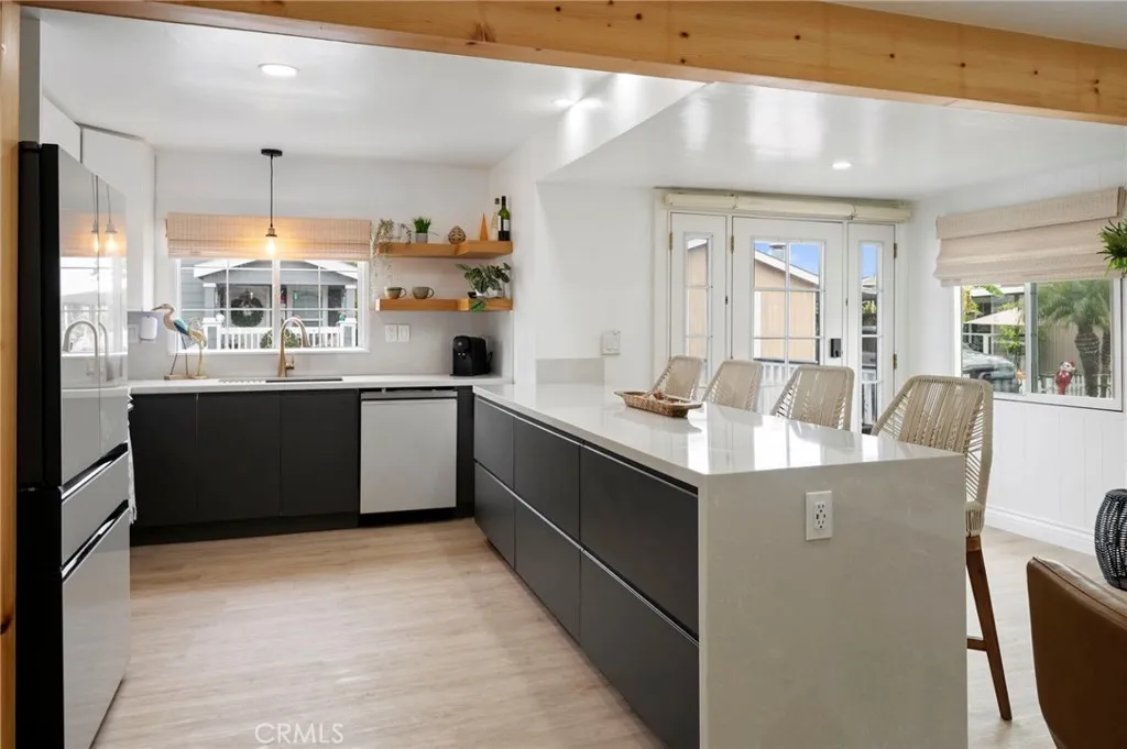 6550 Ponto, Unit 17 Carlsbad, CA 92011 - Photo 16 of 48 a kitchen with kitchen island a sink counter top space and appliances