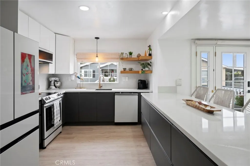 6550 Ponto, Unit 17 Carlsbad, CA 92011 - Photo 17 of 48 a kitchen with stainless steel appliances granite countertop a sink stove and refrigerator