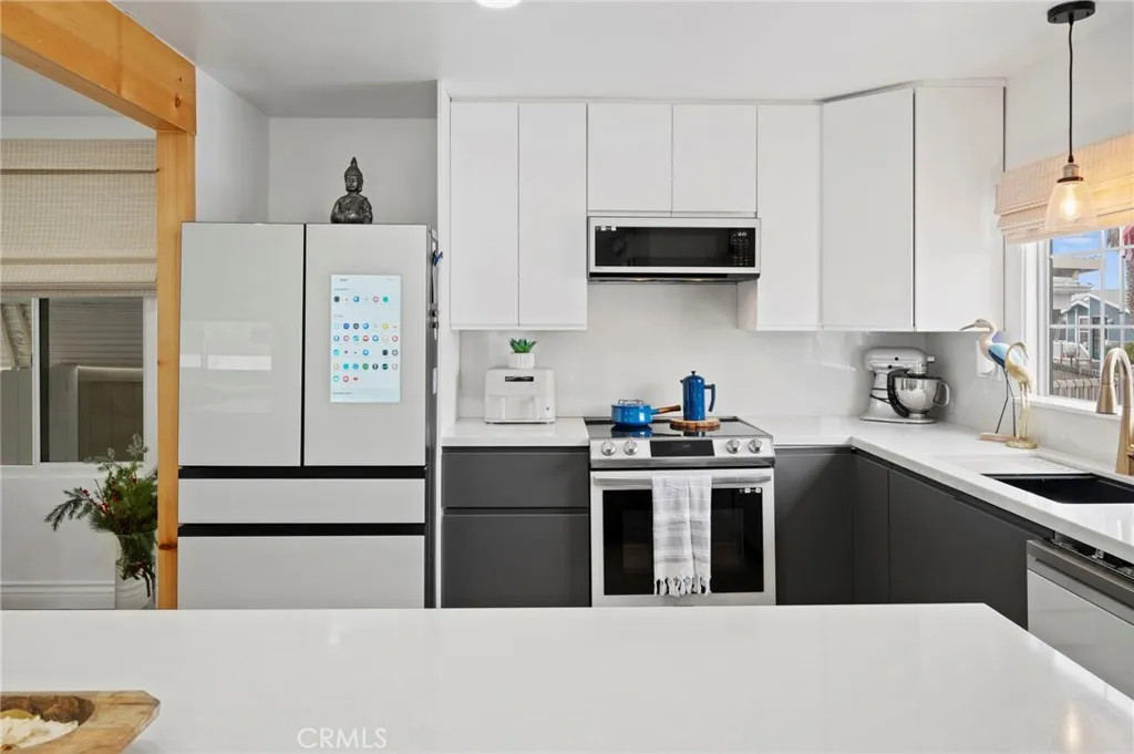 6550 Ponto, Unit 17 Carlsbad, CA 92011 - Photo 19 of 48 a kitchen with stainless steel appliances a stove a sink a refrigerator and cabinets