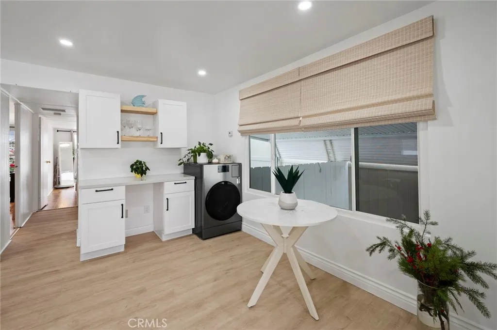 6550 Ponto, Unit 17 Carlsbad, CA 92011 - Photo 22 of 48 a living room with furniture potted plant and a wooden floor