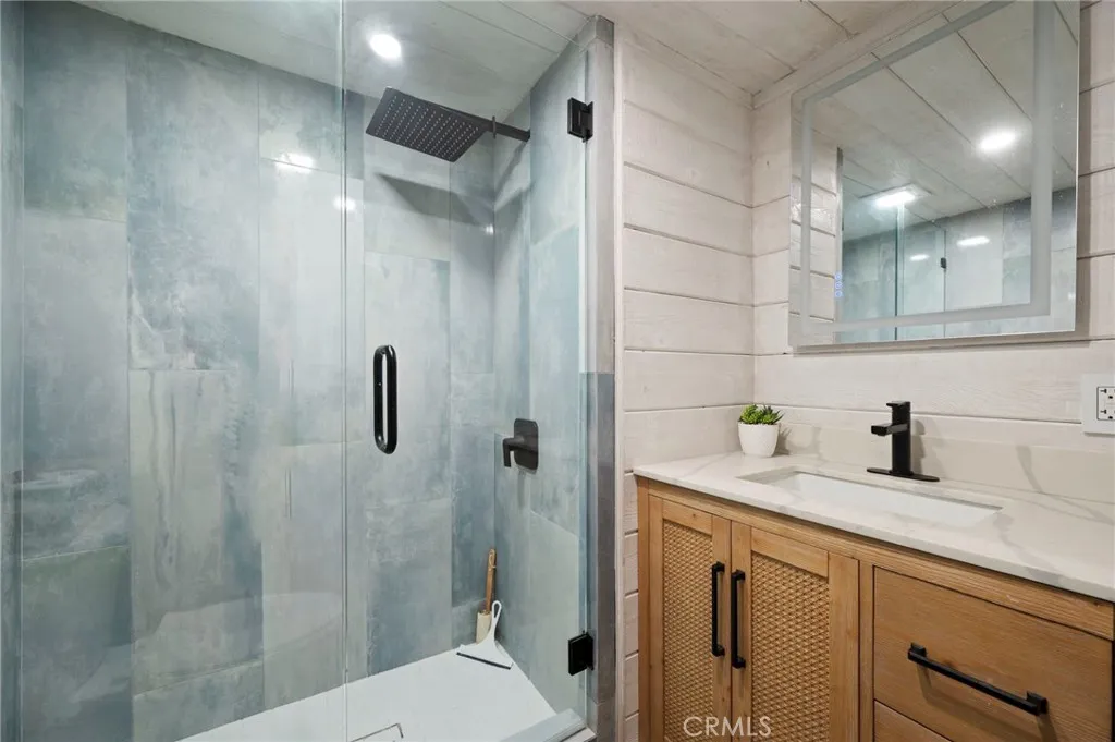 6550 Ponto, Unit 17 Carlsbad, CA 92011 - Photo 26 of 48 a bathroom with a granite countertop sink a toilet and shower
