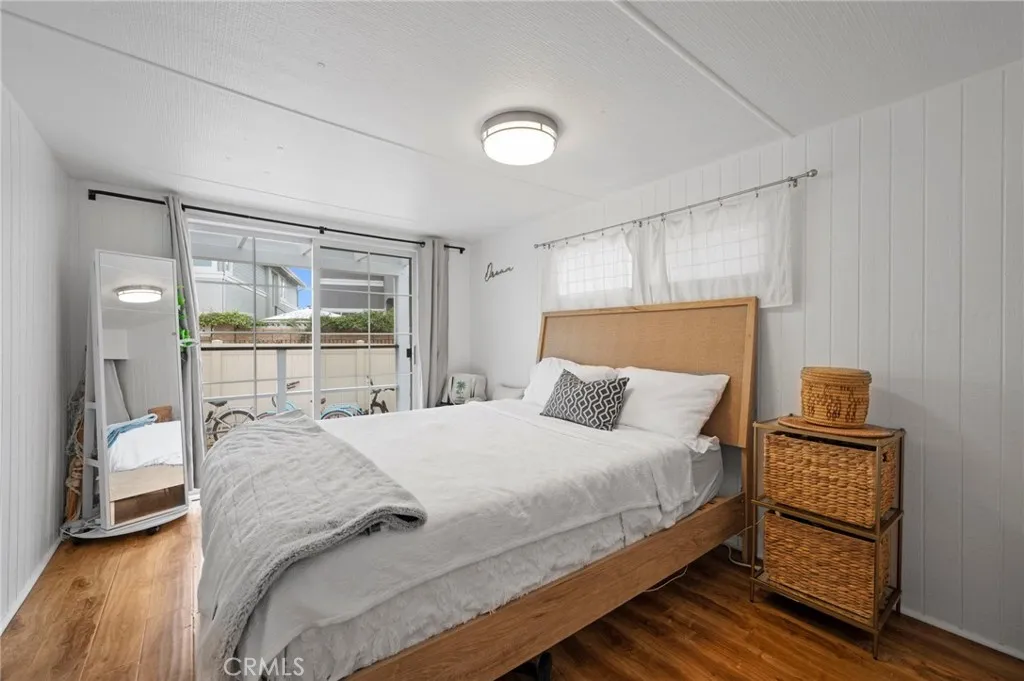 6550 Ponto, Unit 17 Carlsbad, CA 92011 - Photo 28 of 48 a bedroom with a bed and a large window