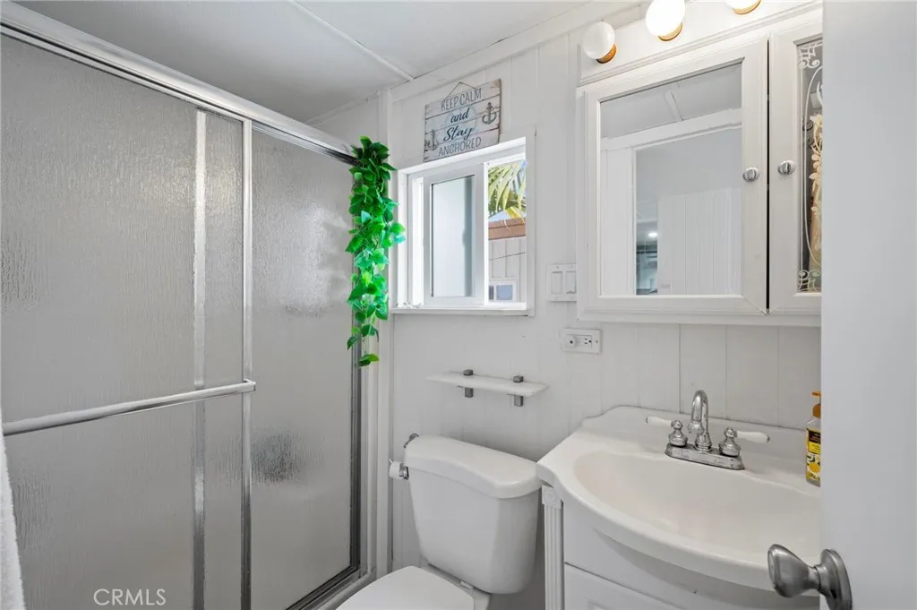 6550 Ponto, Unit 17 Carlsbad, CA 92011 - Photo 34 of 48 a bathroom with a sink a mirror and a shower