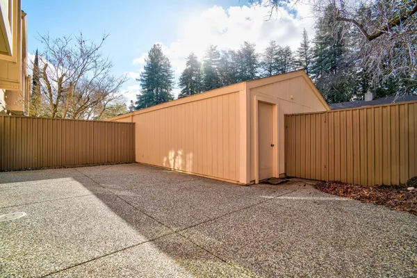 a bedroom with a bed lamp and a large window