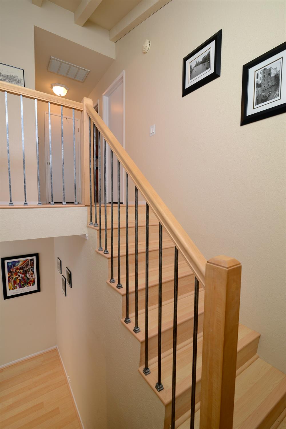 151 Hartnell Place Sacramento, CA 95825 - Photo 15 of 35 a view of staircase with lots of frames on wall and wooden floor
