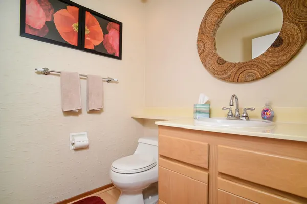 a bathroom with a sink toilet vanity and shower