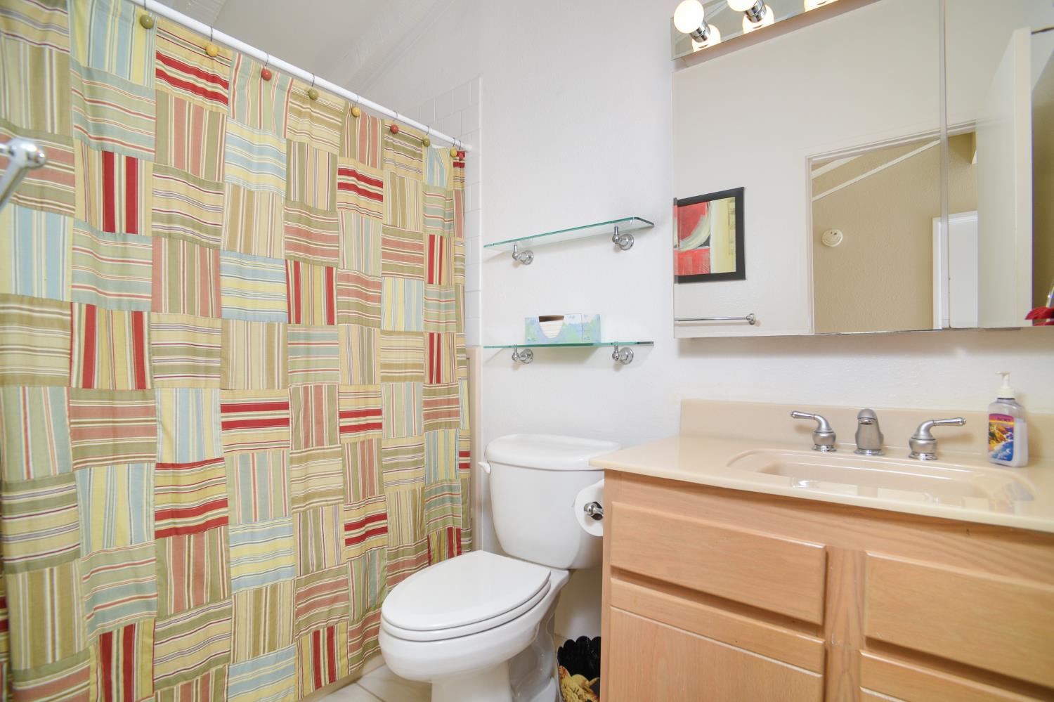 151 Hartnell Place Sacramento, CA 95825 - Photo 23 of 35 a bathroom with a sink toilet vanity and shower