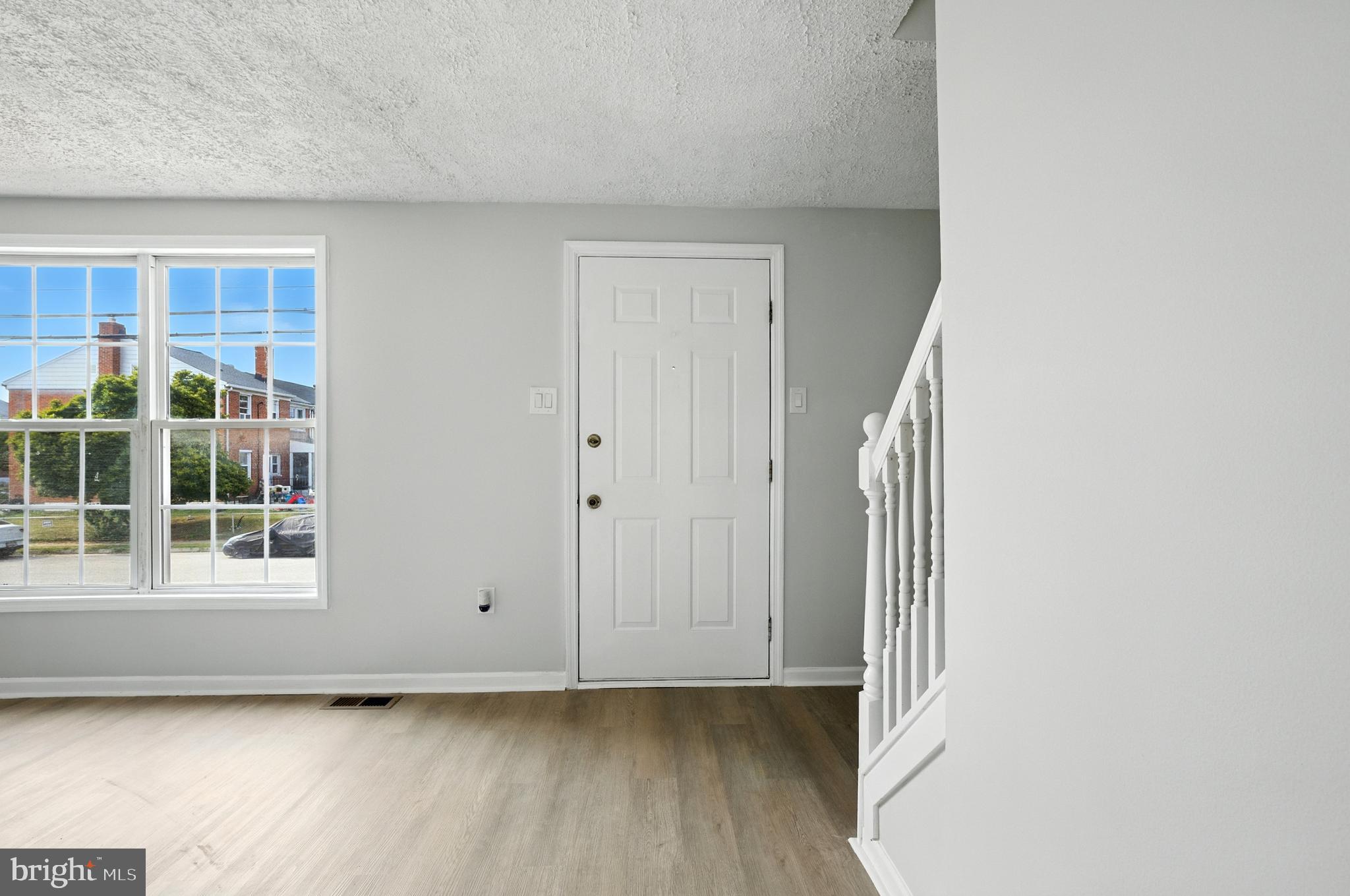 209 Magnolia Terrace Baltimore, MD 21221 - Photo 2 of 50 an empty room with wooden floor and windows