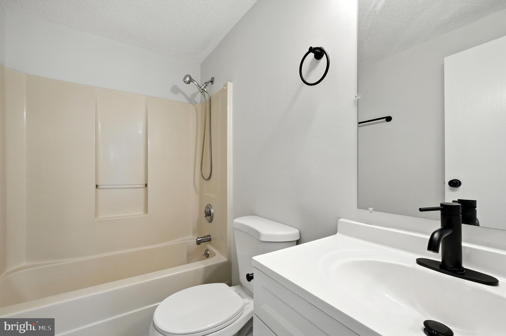 209 Magnolia Terrace Baltimore, MD 21221 - Photo 21 of 50 a bathroom with a granite countertop bathtub shower sink vanity and toilet