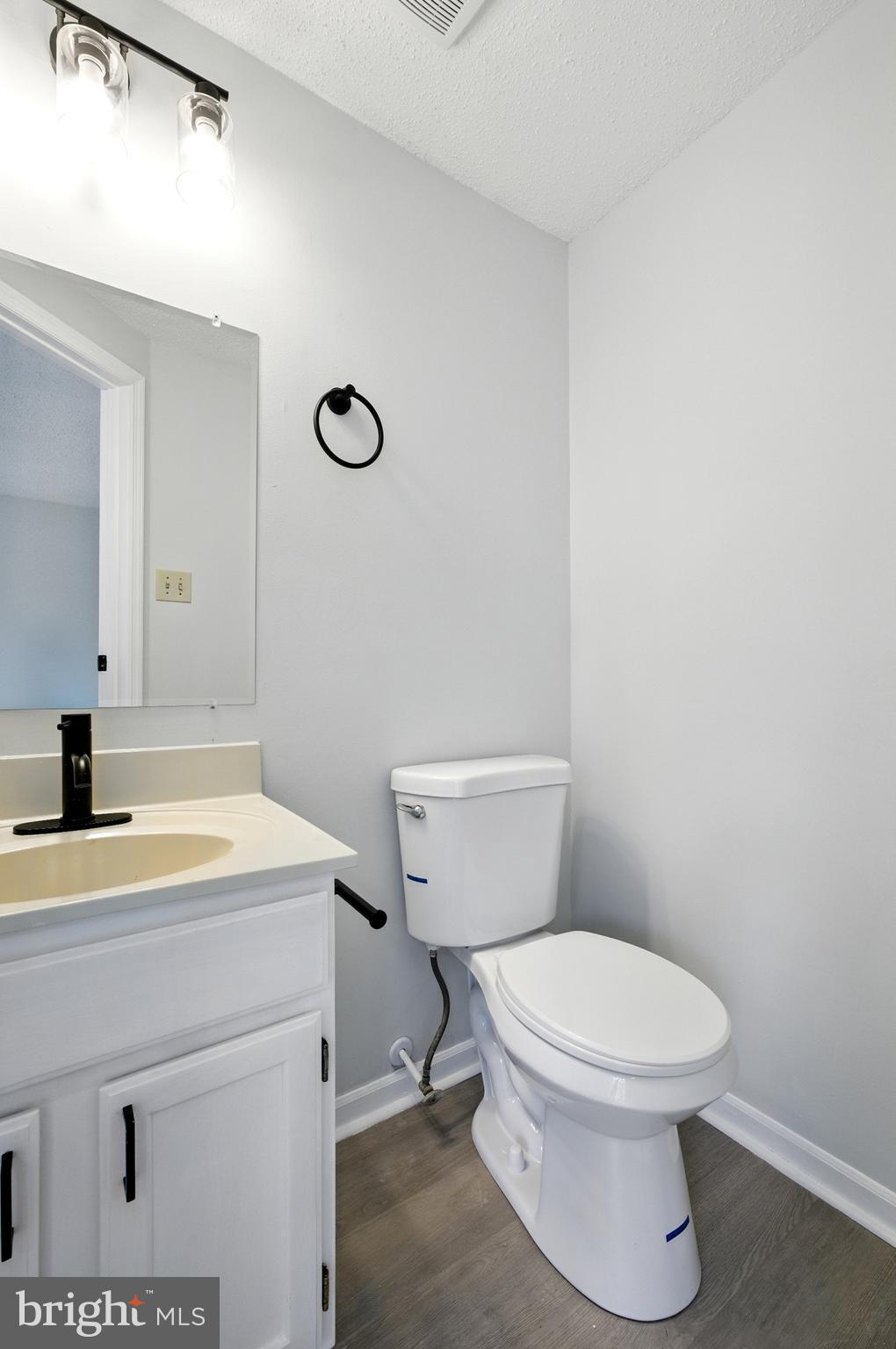 209 Magnolia Terrace Baltimore, MD 21221 - Photo 27 of 50 a bathroom with a sink a toilet and a mirror