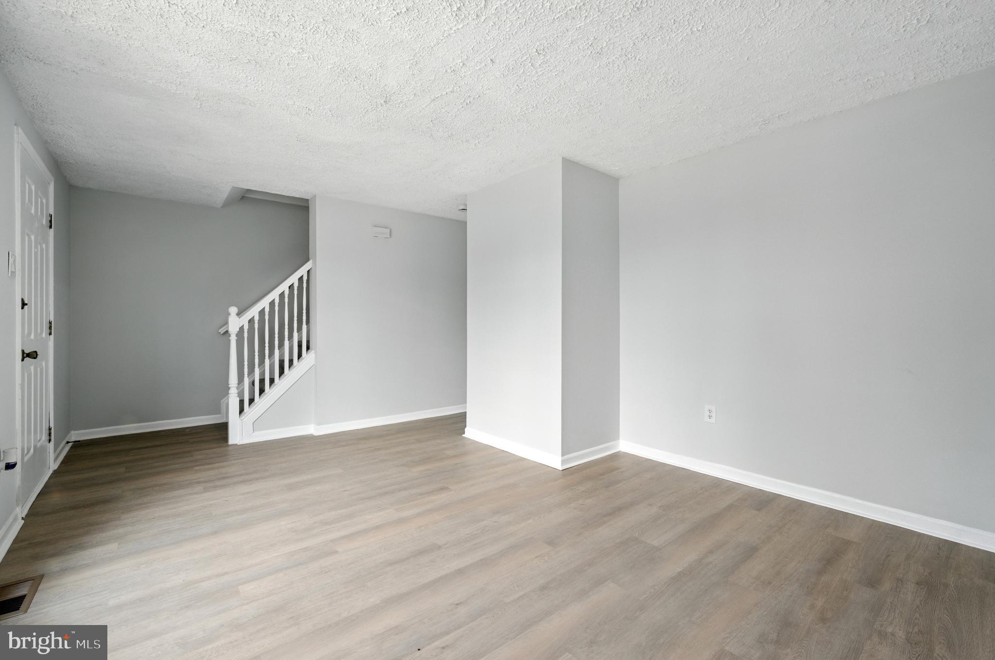 209 Magnolia Terrace Baltimore, MD 21221 - Photo 5 of 50 a view of an empty room with wooden floor