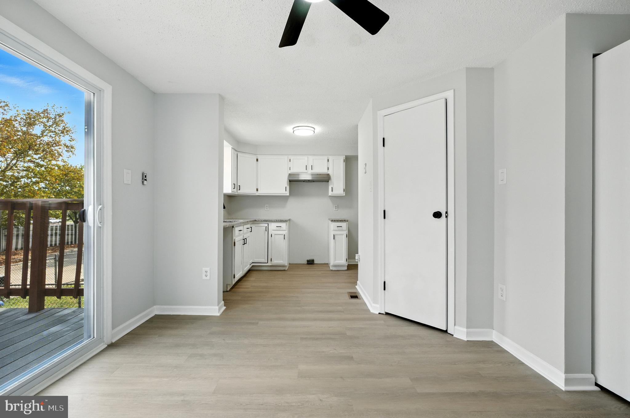 209 Magnolia Terrace Baltimore, MD 21221 - Photo 8 of 50 a view of kitchen and empty room with wooden floor