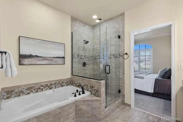 a bathroom with a tub shower and sink