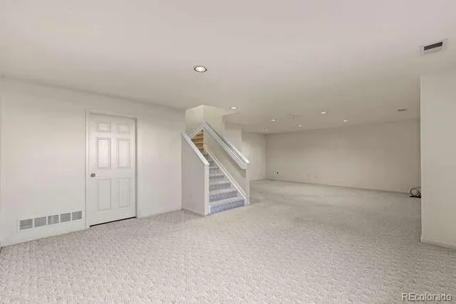 a view of an empty room with stairs