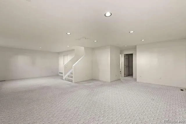 an empty room with a kitchen and a window