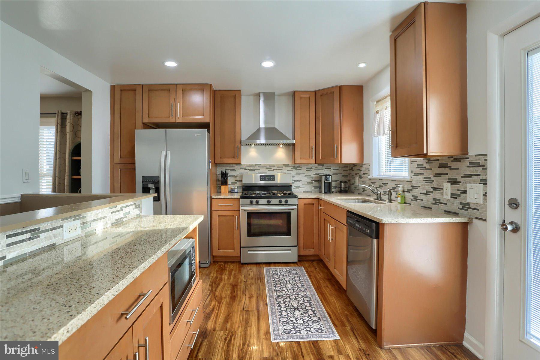 1181 Kingsley Road Camp Hill, PA 17011 - Photo 9 of 40 a kitchen with stainless steel appliances granite countertop a stove a sink and a refrigerator