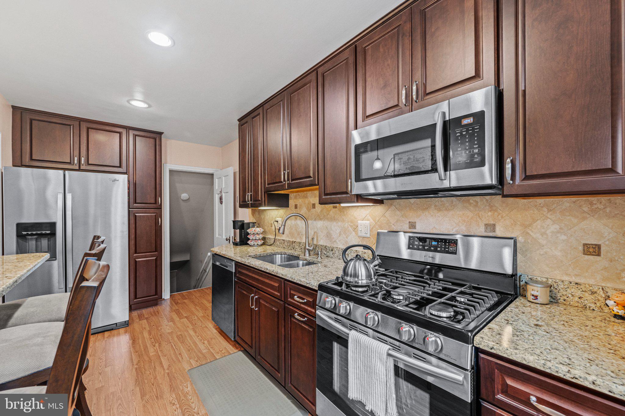 406 Greenlow Road Baltimore, MD 21228 - Photo 14 of 31 Modern kitchen with rich cabinetry.