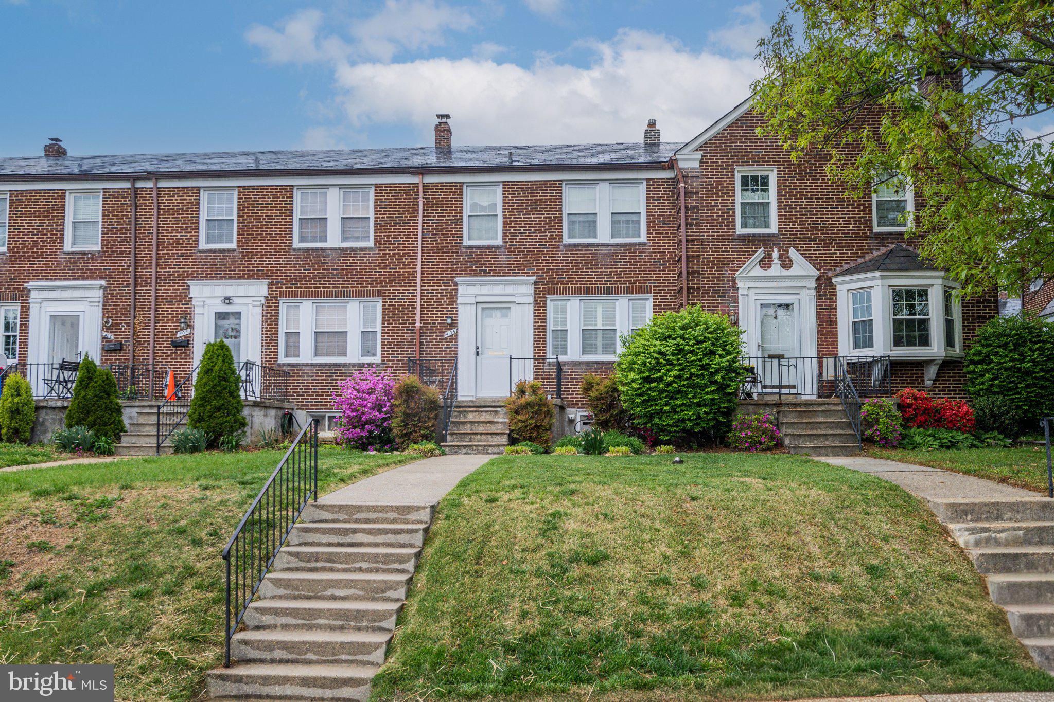 406 Greenlow Road Baltimore, MD 21228 - Photo 2 of 31 Charming brick townhomes with vibrant gardens.