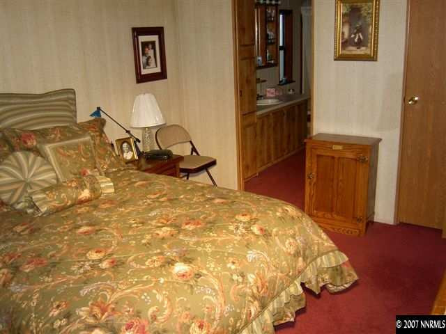 17610 Macaw Lane Reno, NV 89508 - Photo 3 of 9 a bedroom with a bed and wooden floor
