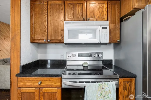 a kitchen with granite countertop wooden cabinets a sink and dishwasher