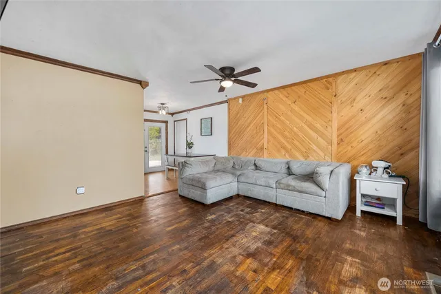 a view of a room with wooden floor and windows