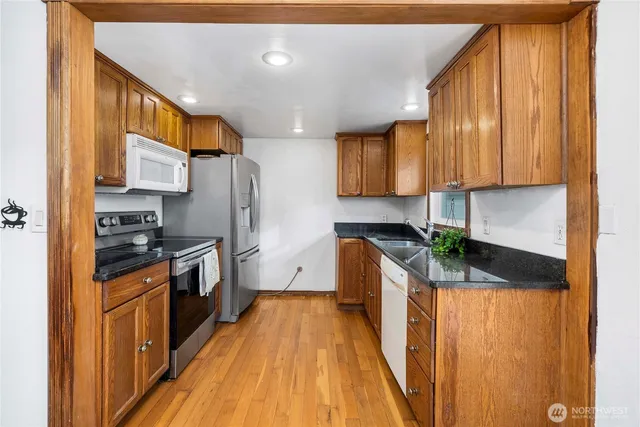 a stove top oven sitting inside of a kitchen
