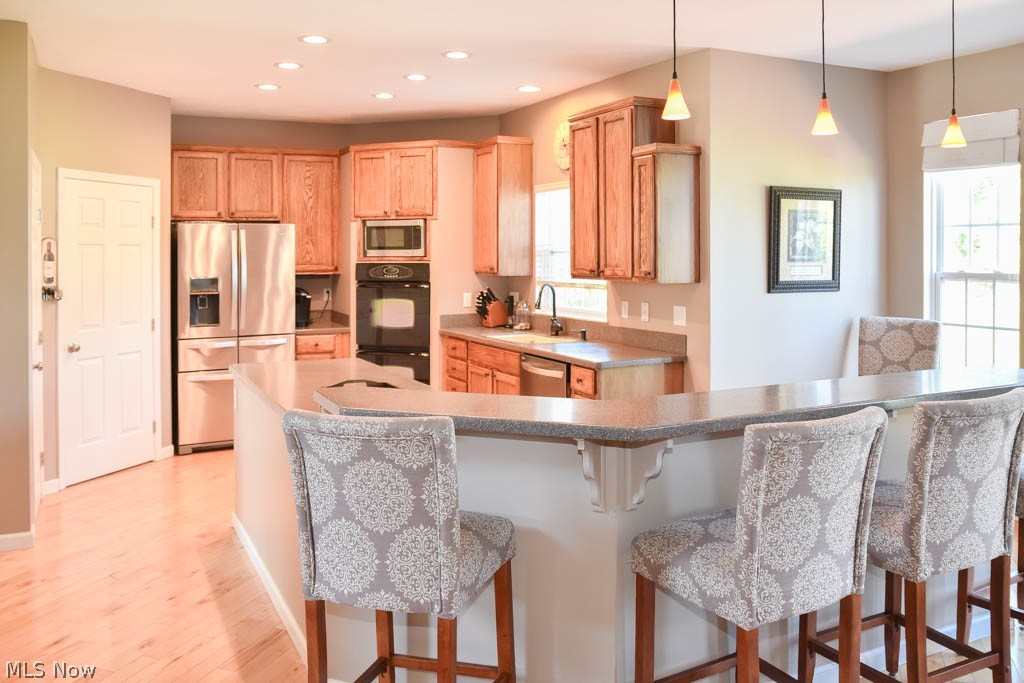 Beautiful kitchen with a large breakfast bar and solid surface countertops.