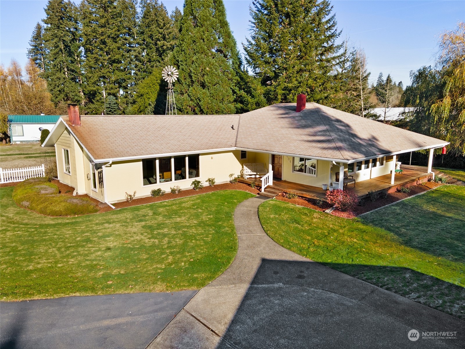 a aerial view of a house with swimming pool and large trees