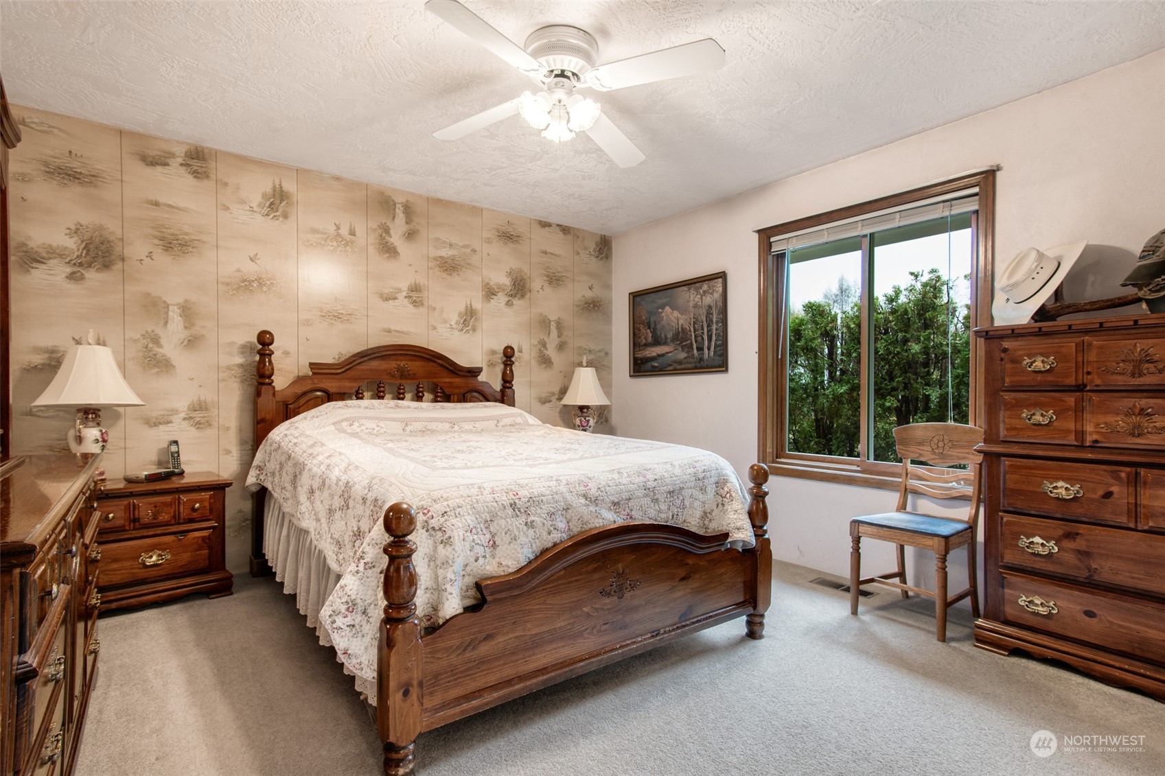 9406 Crete Street Southeast Olympia, WA 98501 - Photo 24 of 38 a spacious bedroom with a bed a chandelier and a large window with the outer view