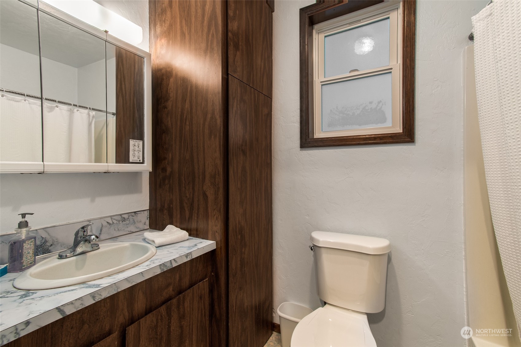 9406 Crete Street Southeast Olympia, WA 98501 - Photo 32 of 38 a bathroom with a toilet sink vanity and mirror