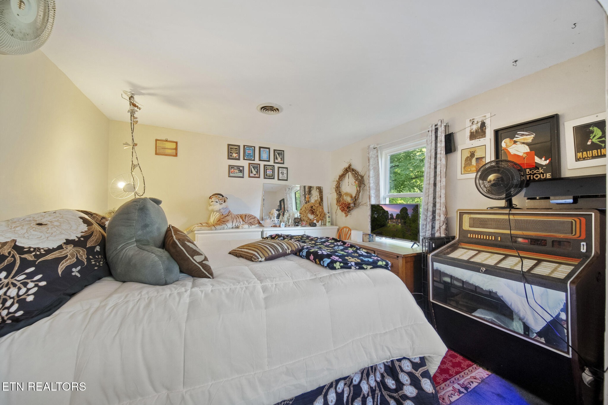 4880 Shell Lane Knoxville, TN 37918 - Photo 13 of 37 a bedroom with a bed a mirror and a flat screen tv