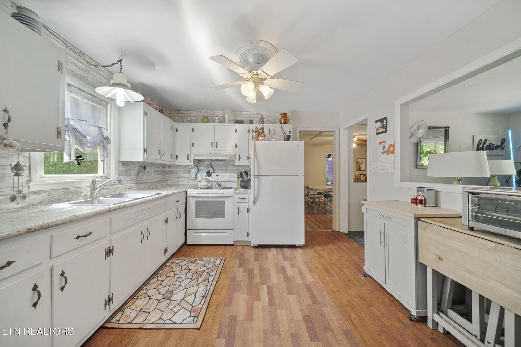 4880 Shell Lane Knoxville, TN 37918 - Photo 18 of 37 a kitchen with cabinets wooden floor and stainless steel appliances