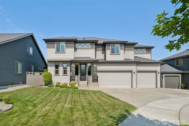 a front view of a house with a yard garage and outdoor seating