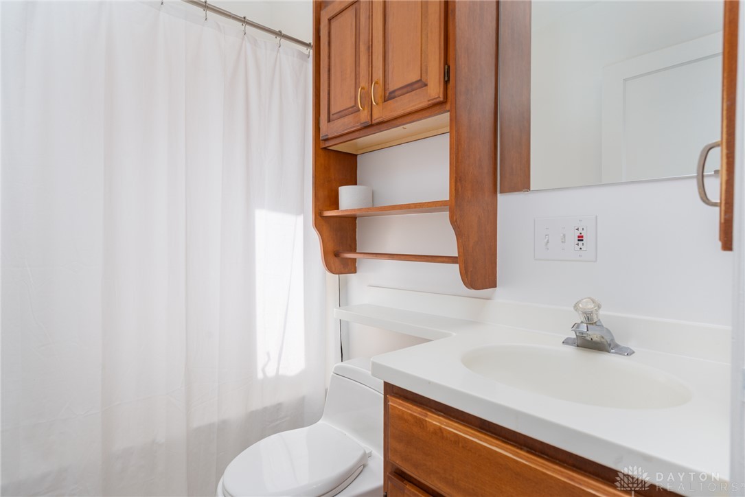 326 North Bromfield Road Kettering, OH 45429 - Photo 16 of 30 This bathroom features classic wooden cabinetry and a bright, functional vanity area.