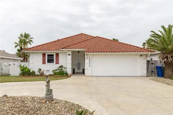 a front view of a house with a garden and yard