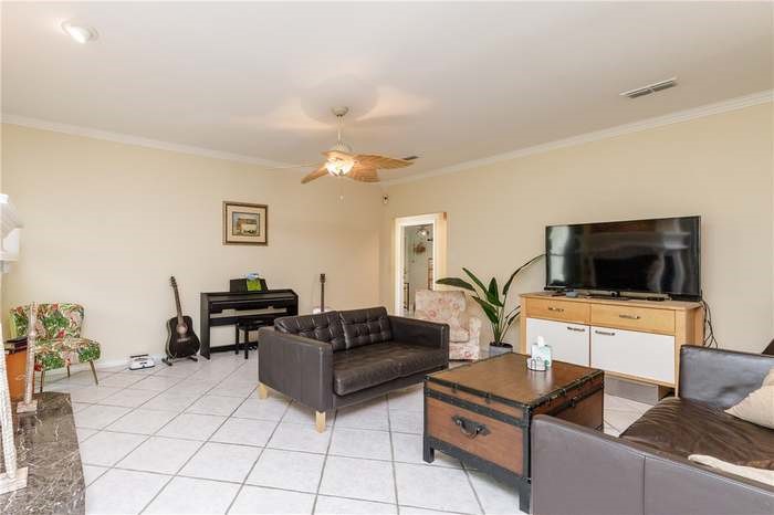 15833 Cuttysark Street Corpus Christi, TX 78418 - Photo 11 of 32 a living room with furniture and a flat screen tv