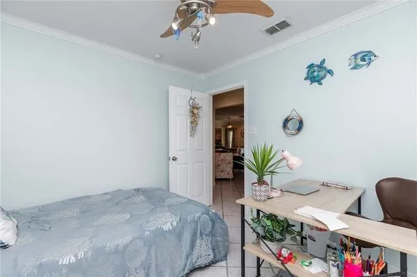 a bed room with a bed and a potted plant