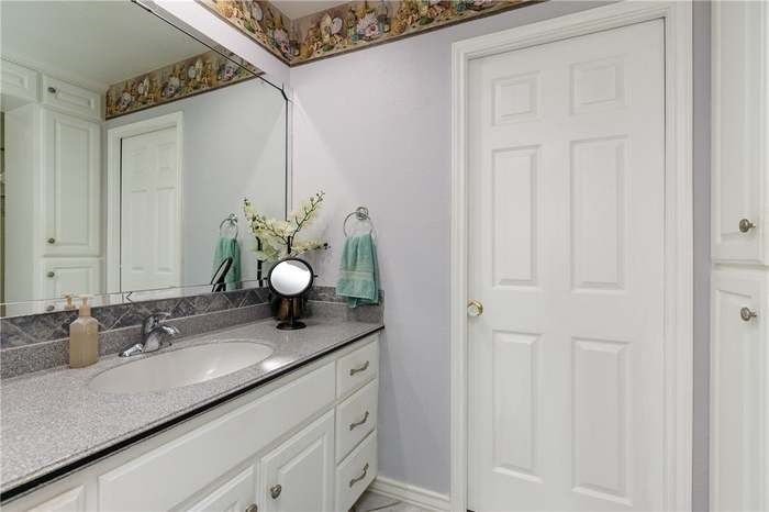 15833 Cuttysark Street Corpus Christi, TX 78418 - Photo 20 of 32 a bathroom with a granite countertop sink and a mirror