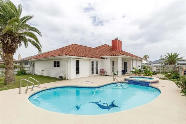 a view of a house with pool and chairs