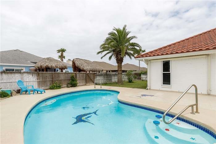 15833 Cuttysark Street Corpus Christi, TX 78418 - Photo 26 of 32 a view of swimming pool with outdoor seating and house in the background