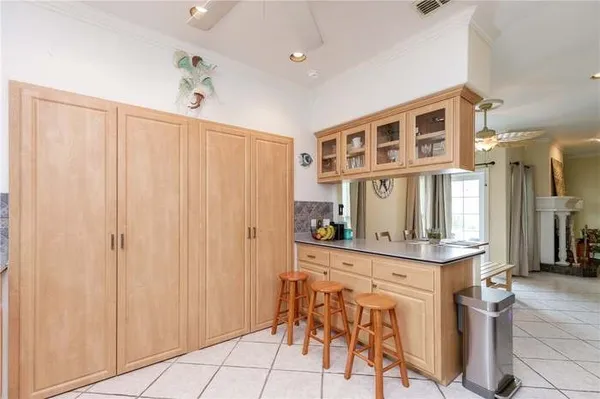 a view of a kitchen with stainless steel appliances granite countertop furniture and a window