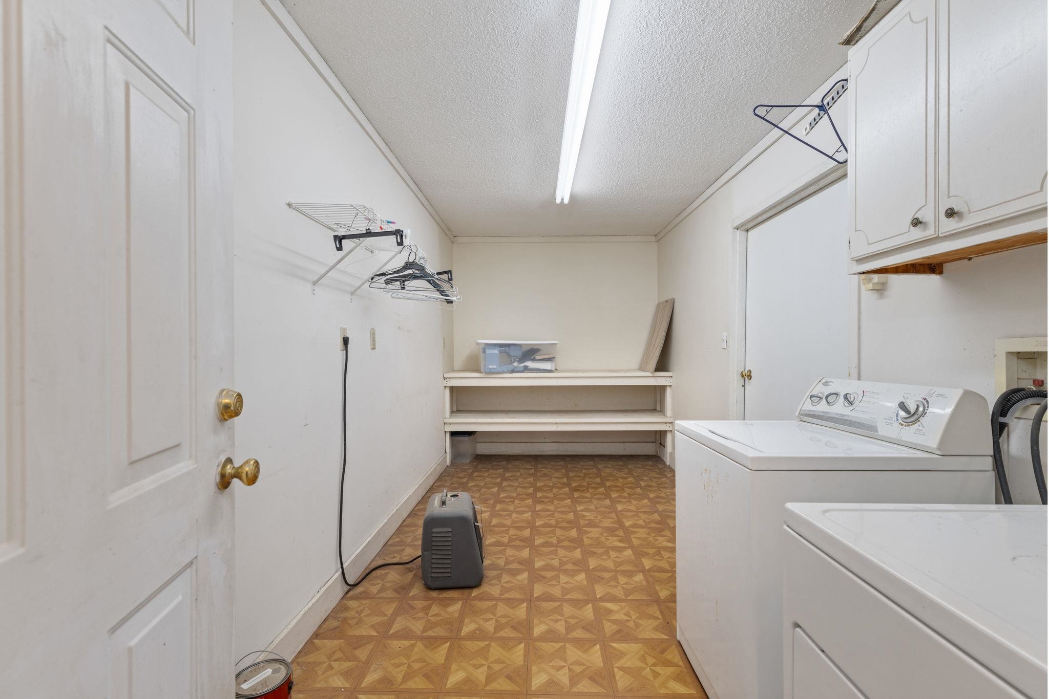 310 County Road 638 Corinth, MS 38834 - Photo 11 of 40 Washroom with a textured ceiling, washing machine and clothes dryer, cabinet space, and light floors