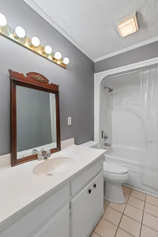 a bathroom with a double vanity sink mirror and toilet
