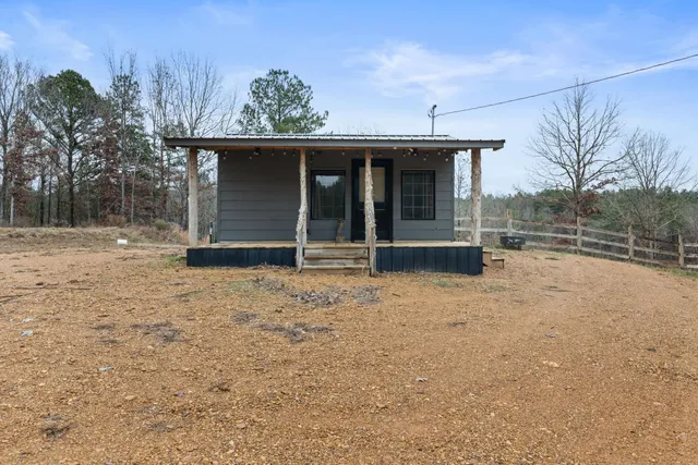 a view of a house with a yard and garage