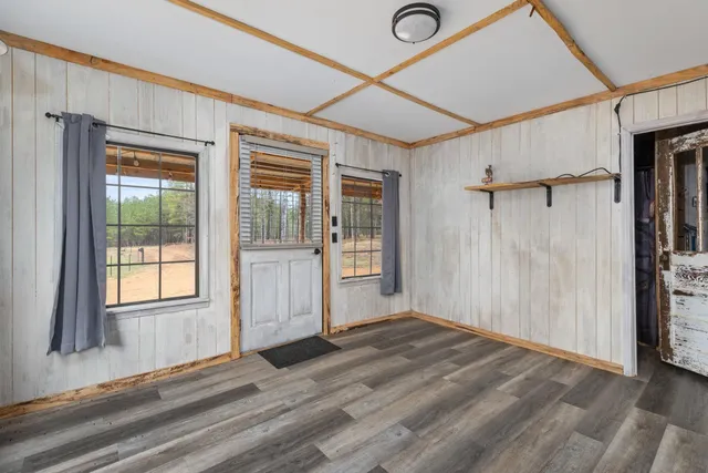 a view of an empty room with wooden floor